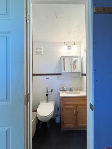 a bathroom with a toilet a sink and mirror
