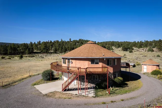 a view of a roof deck with couches and sky view