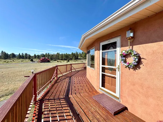 a view of balcony with wooden floor and seating space