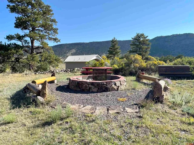 a view of a backyard with sitting area