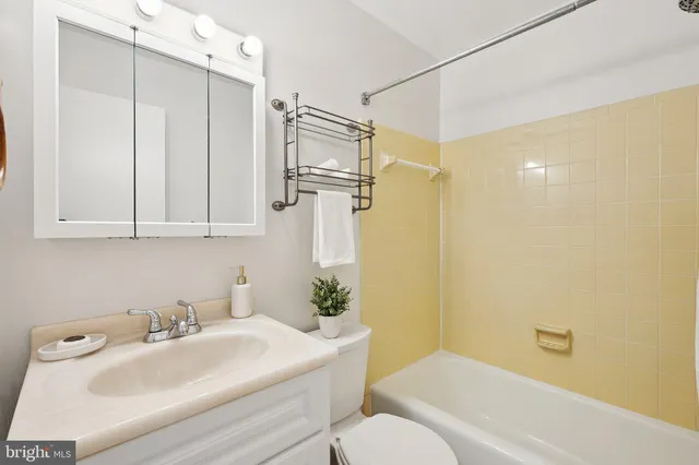 an empty room with chandelier fan