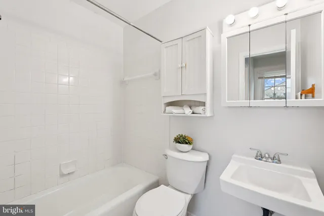 an empty room with a window and a ceiling fan