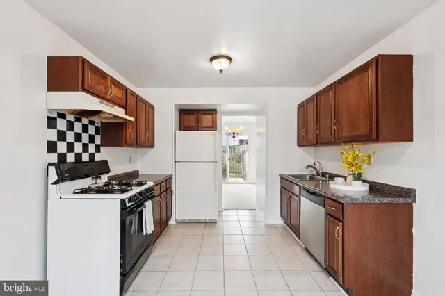 a kitchen with stainless steel appliances a stove a sink and a refrigerator