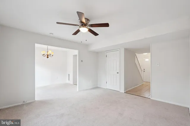 a view of a livingroom with a ceiling fan and entryway