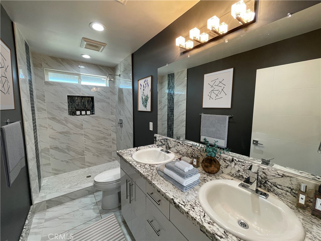10055 East Ave R 10 Littlerock, CA 93543 - Photo 25 of 31 a bathroom with a sink double vanity granite and a mirror