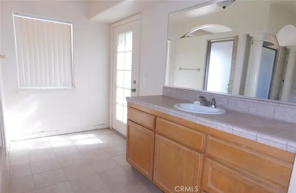 a bathroom with a tub sink and mirror
