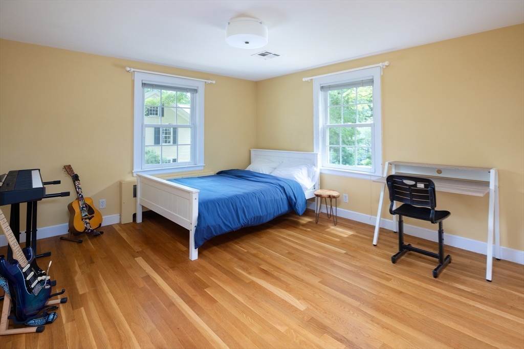 7 Southwick Circle Wellesley, MA 02481 - Photo 13 of 17 a bedroom with a bed and a table in it
