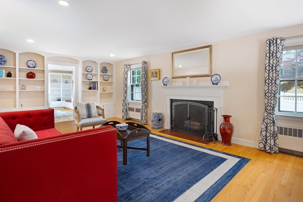 7 Southwick Circle Wellesley, MA 02481 - Photo 3 of 17 a living room with furniture a fireplace and a large window