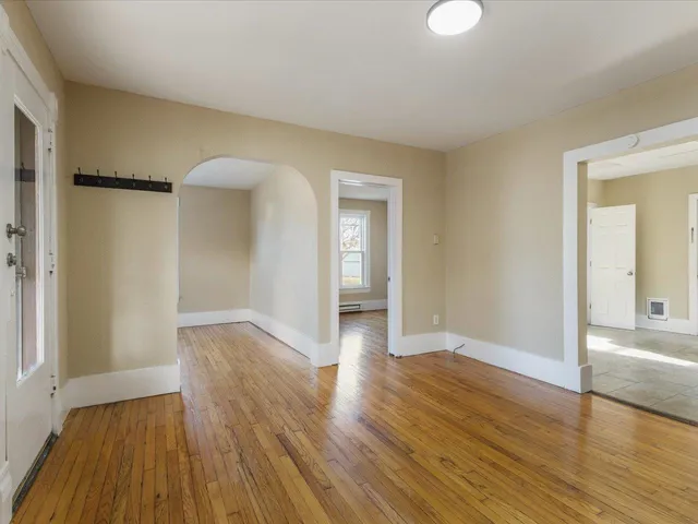 wooden floor in an empty room with a window