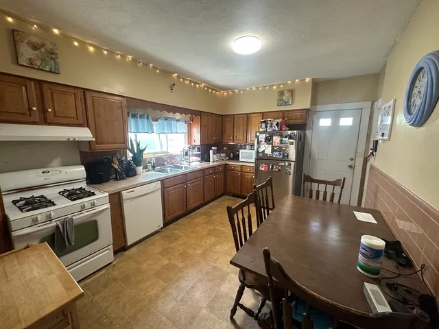 a kitchen with a table chairs stove and cabinets
