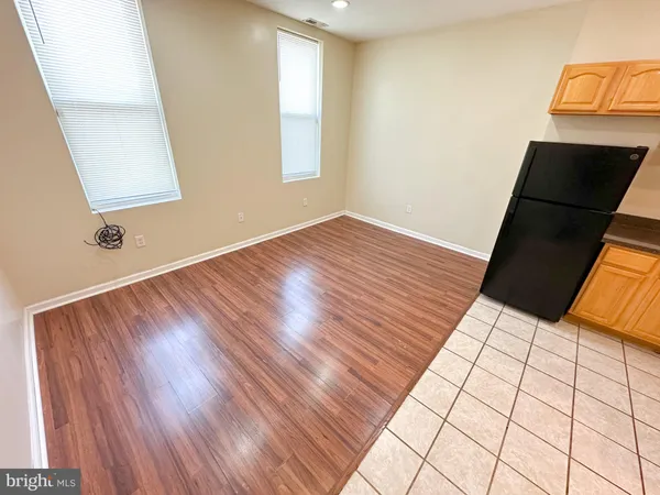 a view of an empty room and wooden floor