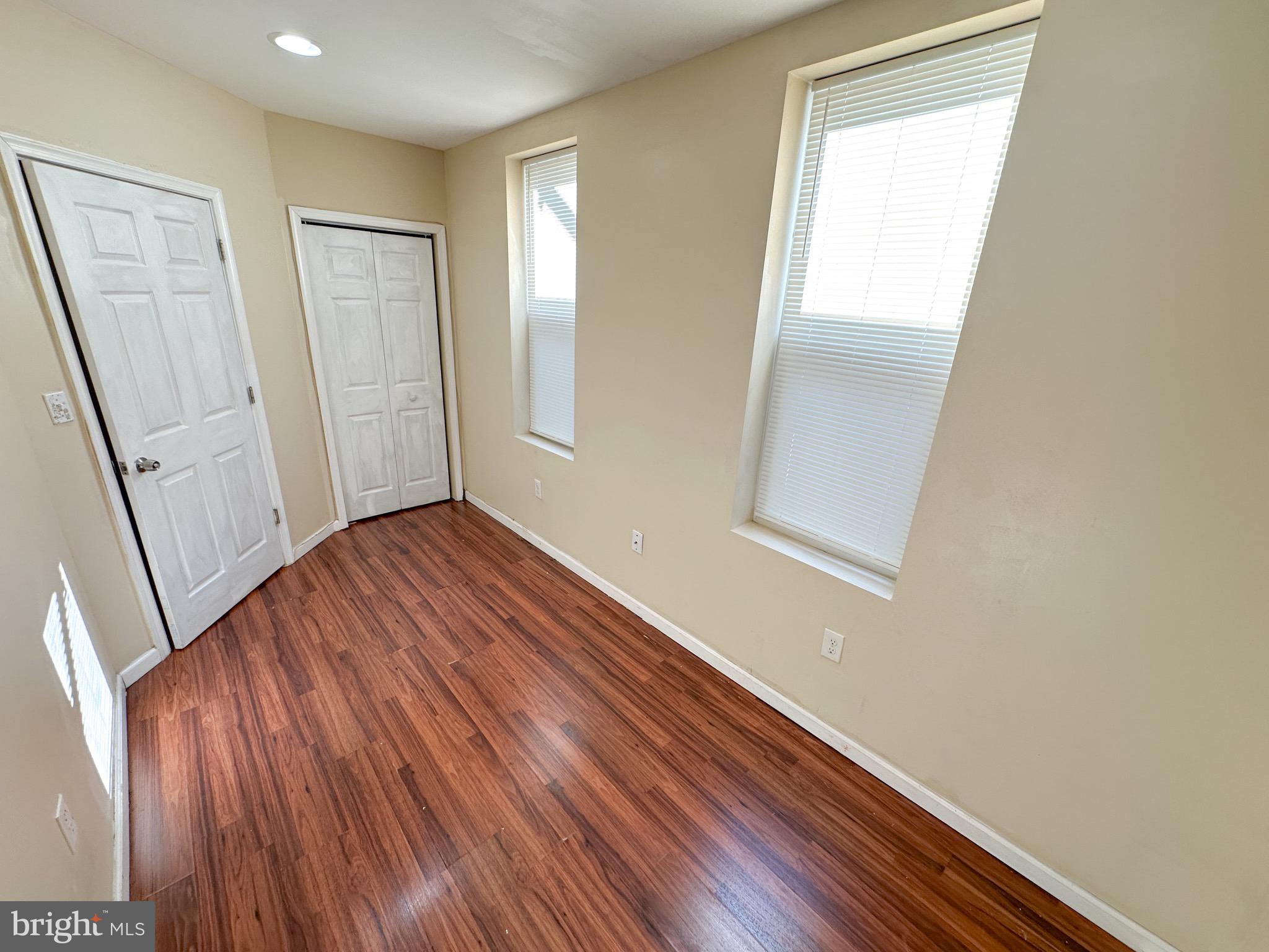 3042 North 15th Street, Unit 2 Philadelphia, PA 19132 - Photo 7 of 10 a view of an empty room with wooden floor and a window