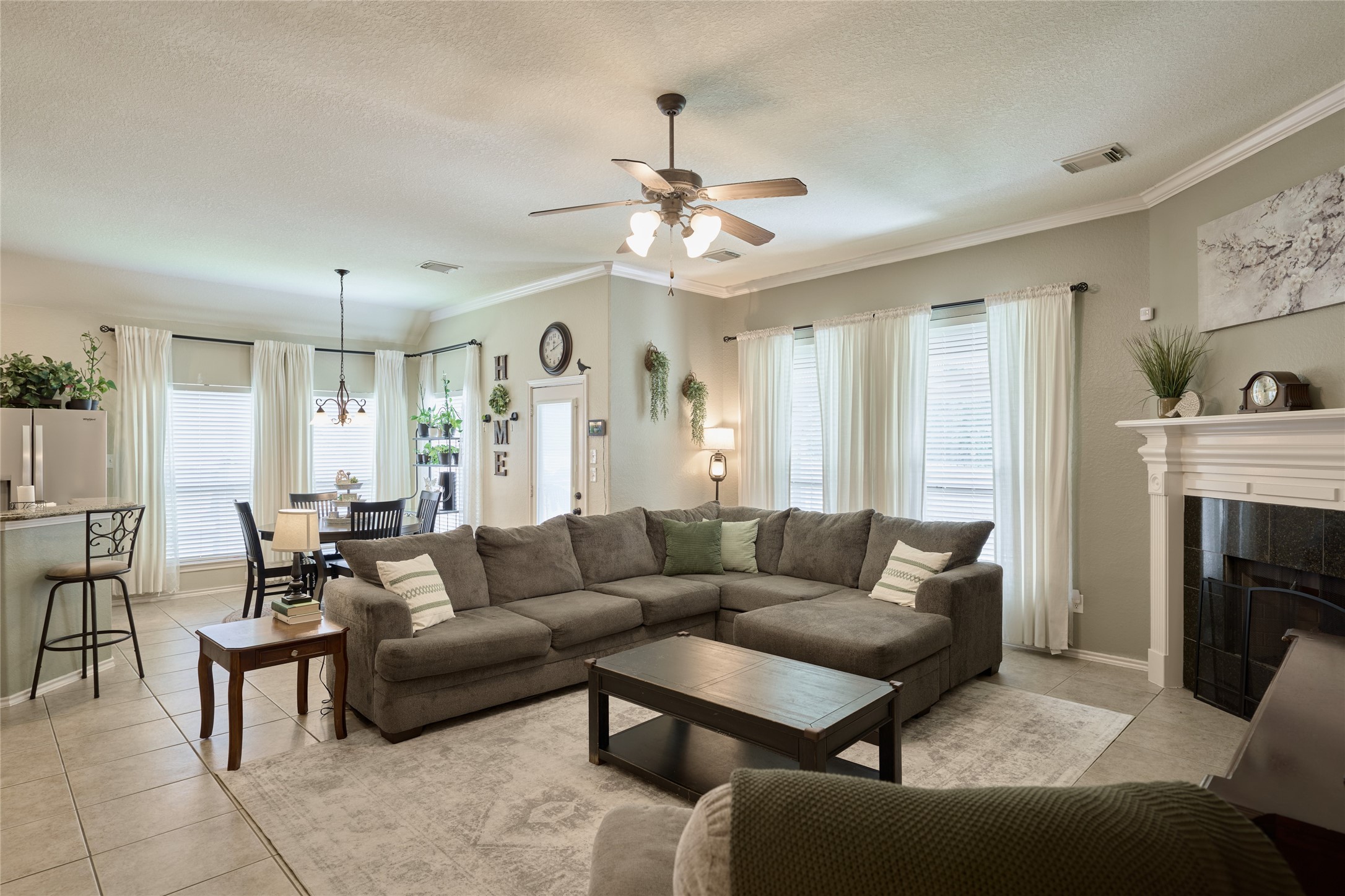 28322 Madelin Manor Lane Spring, TX 77386 - Photo 12 of 46 a living room with furniture a fireplace and a chandelier