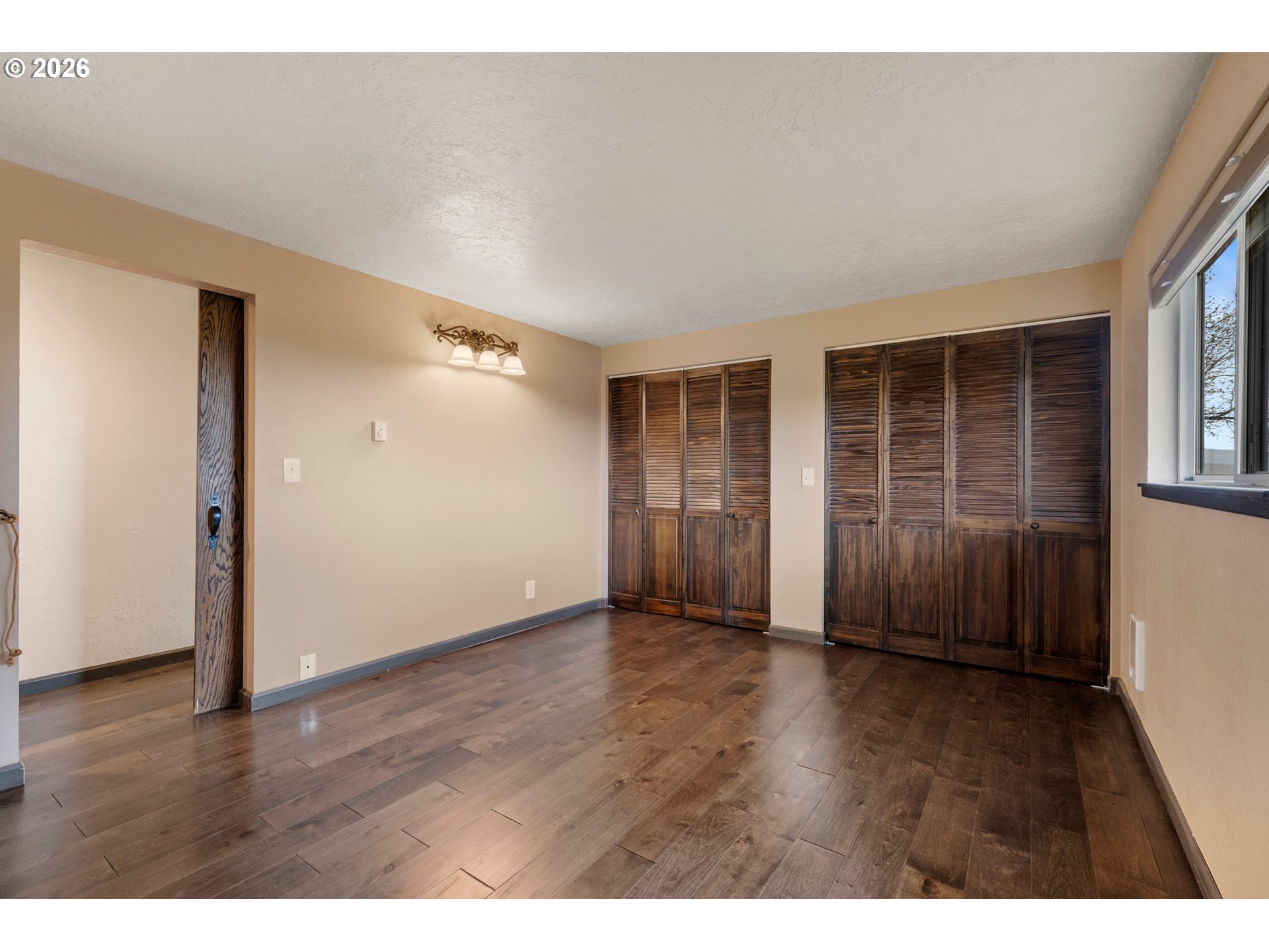 58015 Godley Road Union, OR 97883 - Photo 14 of 44 a view of an empty room with wooden floor and a window