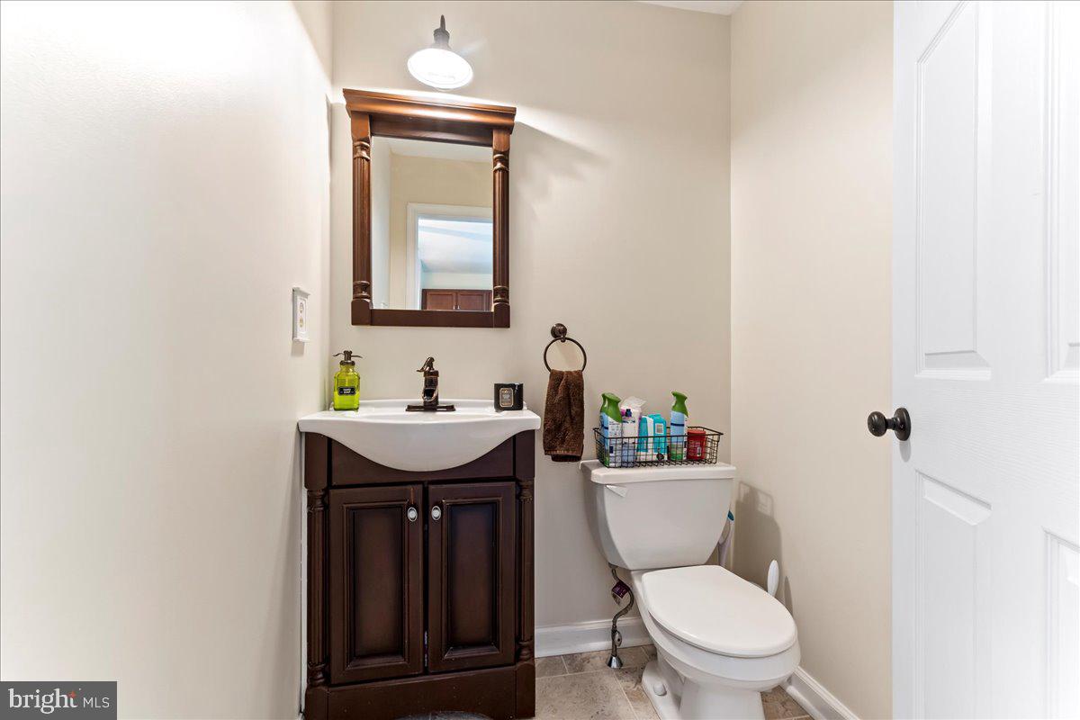 6 Marc Drive Coatesville, PA 19320 - Photo 12 of 25 a bathroom with a granite countertop toilet sink and mirror