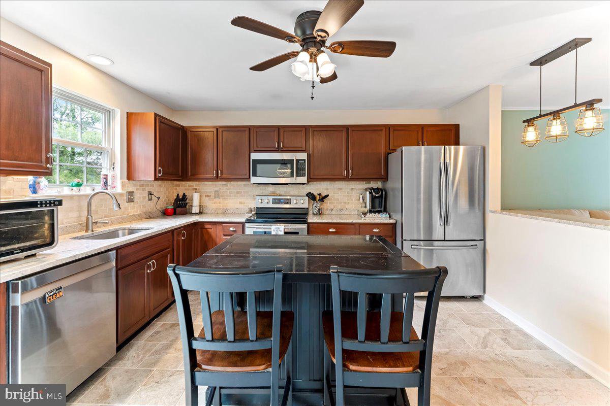 6 Marc Drive Coatesville, PA 19320 - Photo 8 of 25 a kitchen with stainless steel appliances a stove a refrigerator a sink a stove and white cabinets