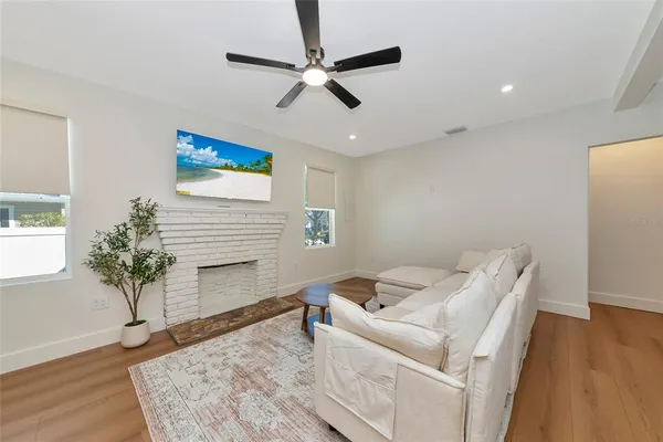 a living room with furniture and a potted plant