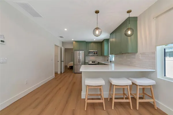a kitchen with a table and chairs in it