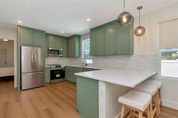 a kitchen with cabinets and stainless steel appliances