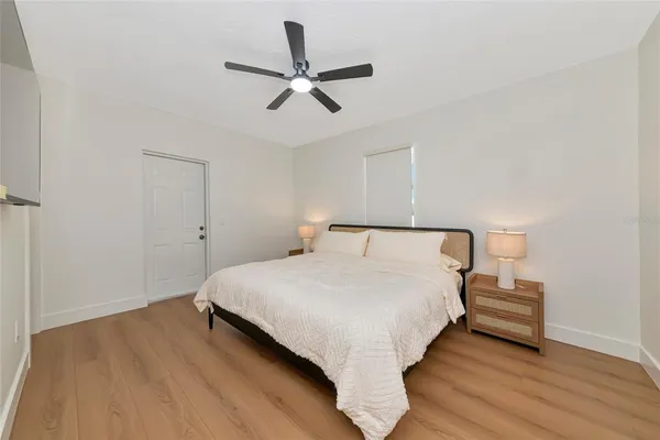 a bedroom with a bed and a ceiling fan