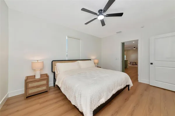 a bedroom with a bed and a painting on the wall