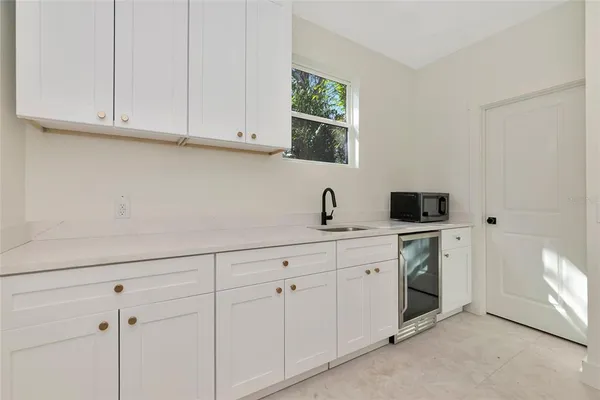 a bathroom with a granite countertop sink a toilet and shower
