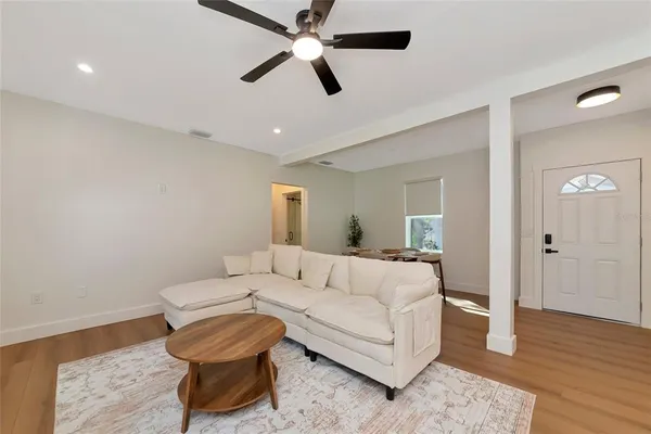 a living room with furniture and a wooden floor