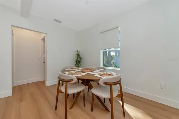 a view of a dining room with furniture and wooden floor
