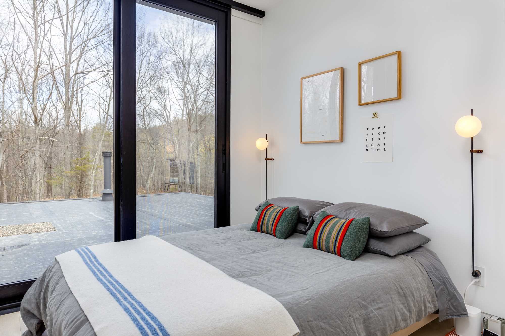 283 Willow Glen Road Milan, NY 12571 - Photo 10 of 23 a bedroom with a large bed and a large window