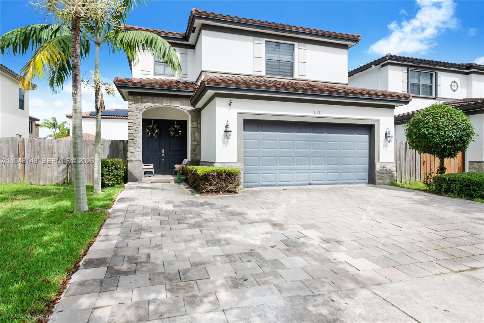 a front view of a house with a yard and garage