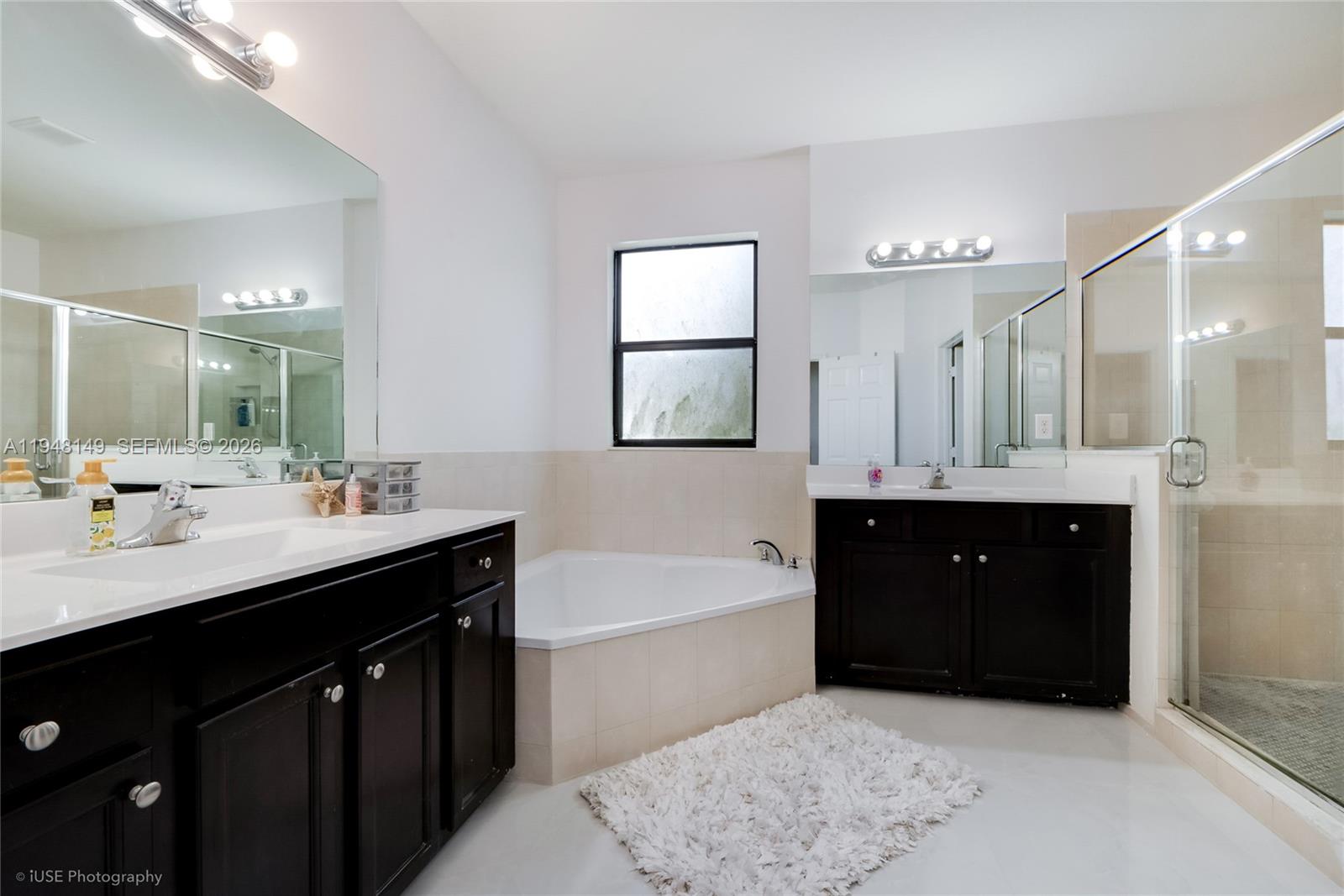 11711 Southwest 254th Street Homestead, FL 33032 - Photo 12 of 17 a bathroom with a tub sink double vanity and mirror