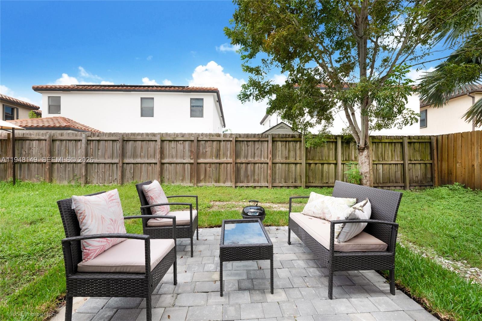 11711 Southwest 254th Street Homestead, FL 33032 - Photo 15 of 17 a view of a chairs and table in the back yard of the house