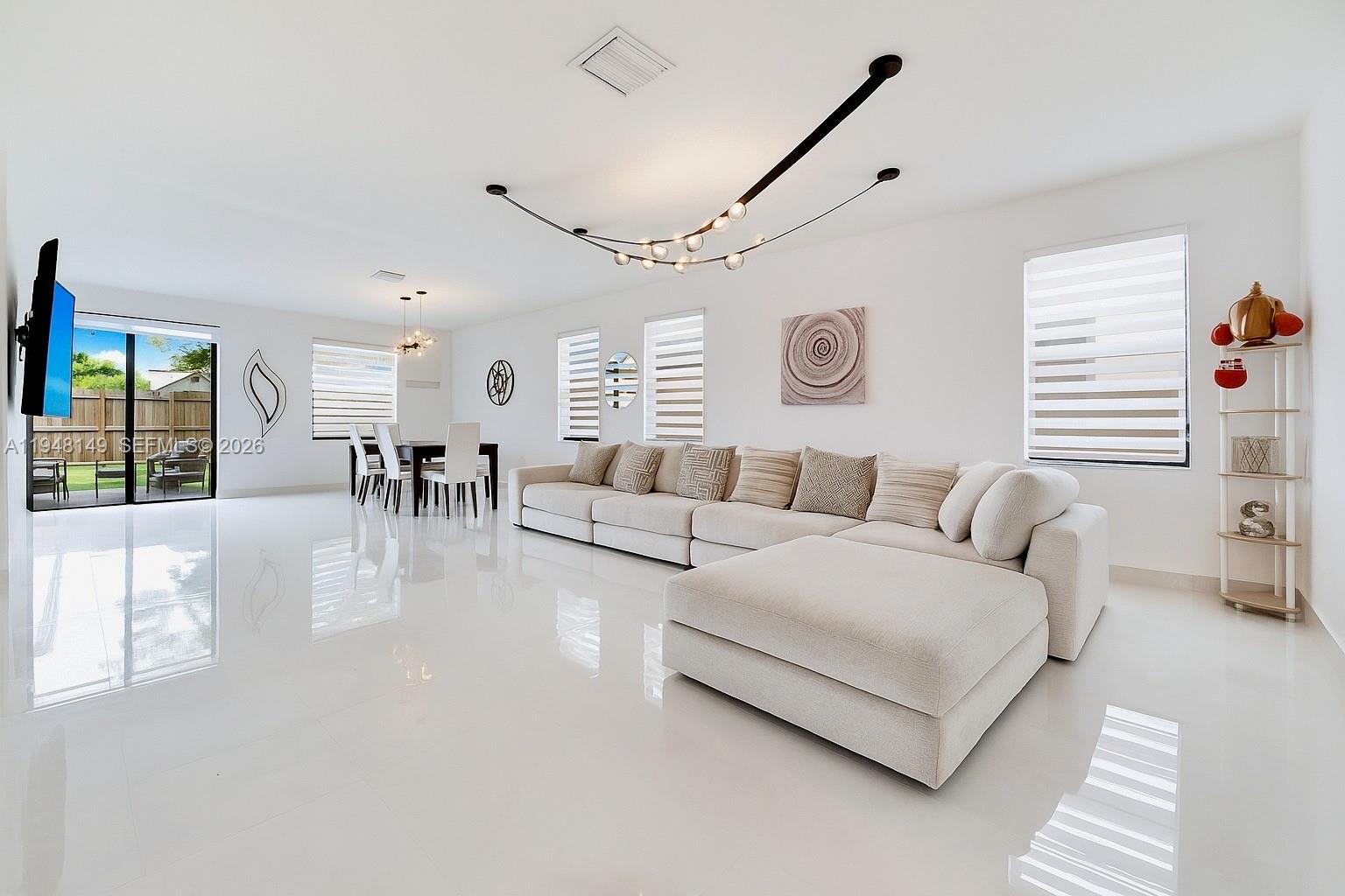 11711 Southwest 254th Street Homestead, FL 33032 - Photo 3 of 17 a living room with furniture and a large window