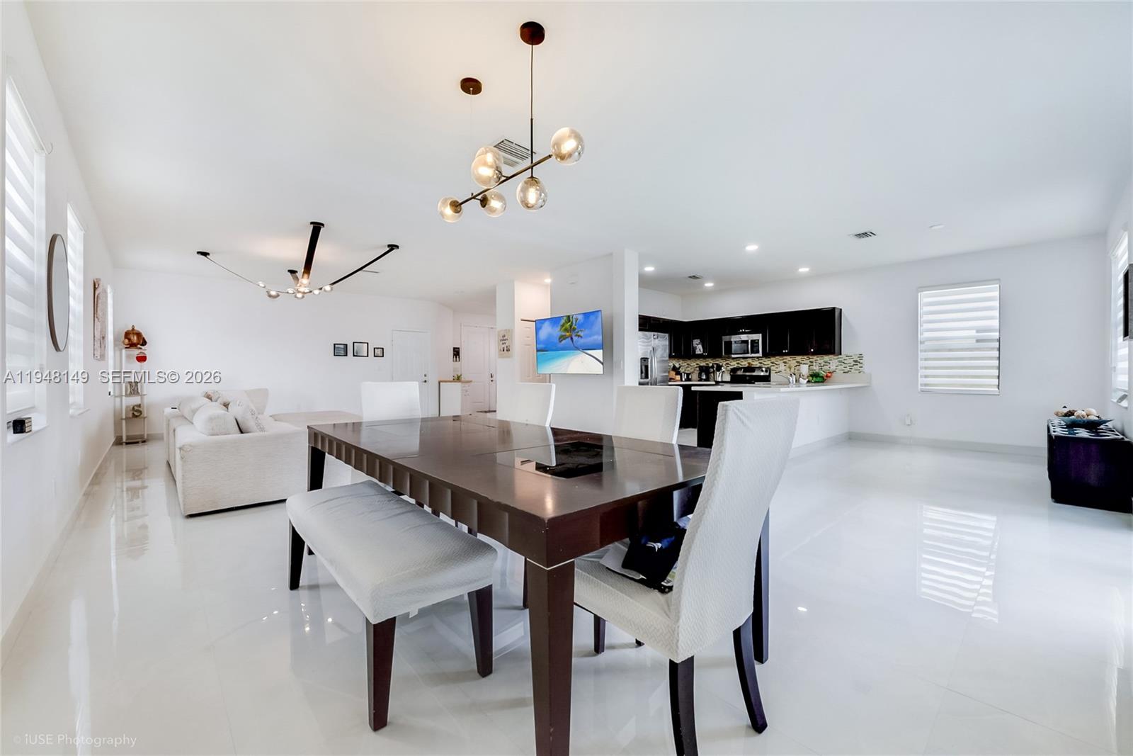 11711 Southwest 254th Street Homestead, FL 33032 - Photo 5 of 17 a view of a dining room with furniture and wooden floor