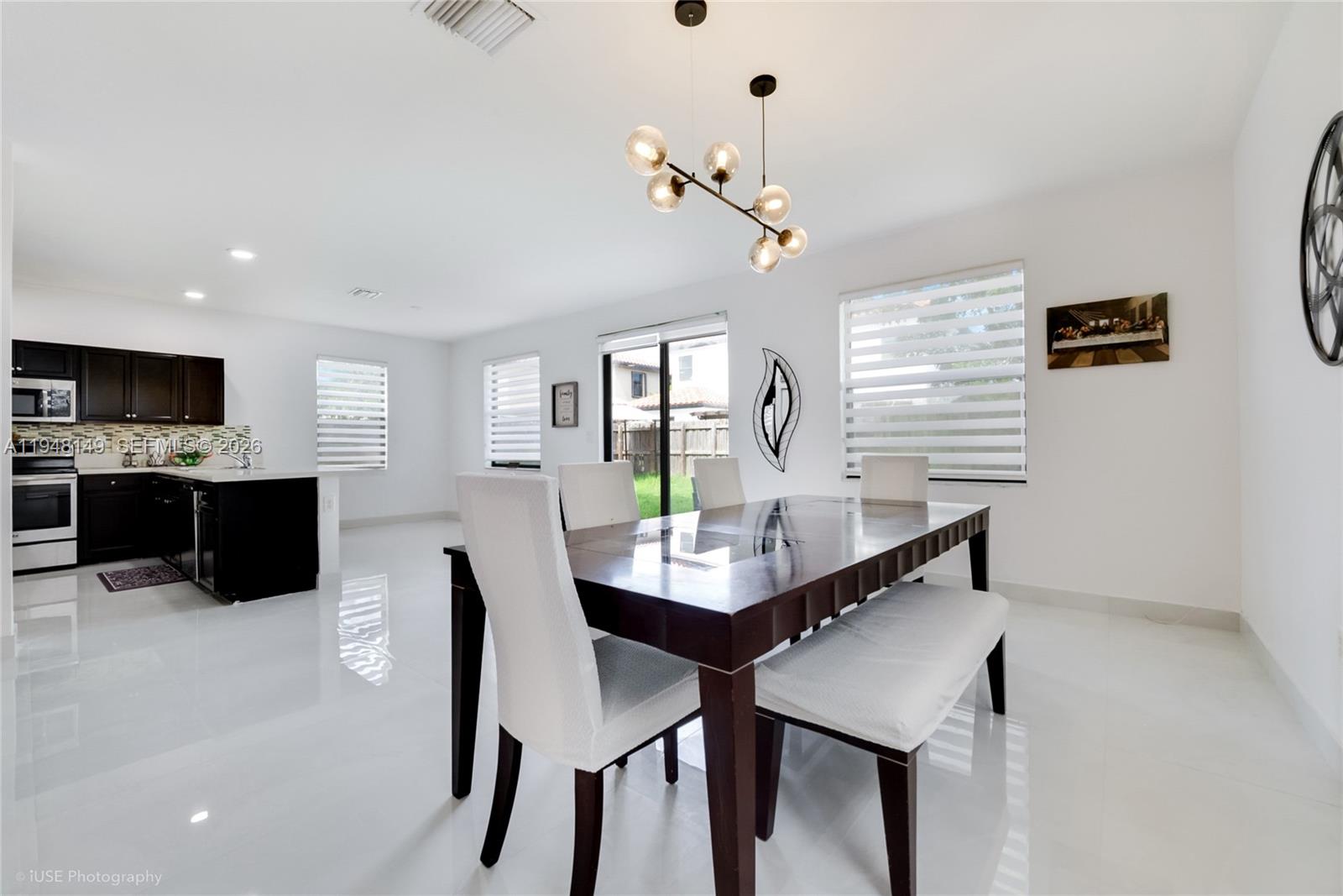 11711 Southwest 254th Street Homestead, FL 33032 - Photo 6 of 17 a view of a dining room with furniture and wooden floor