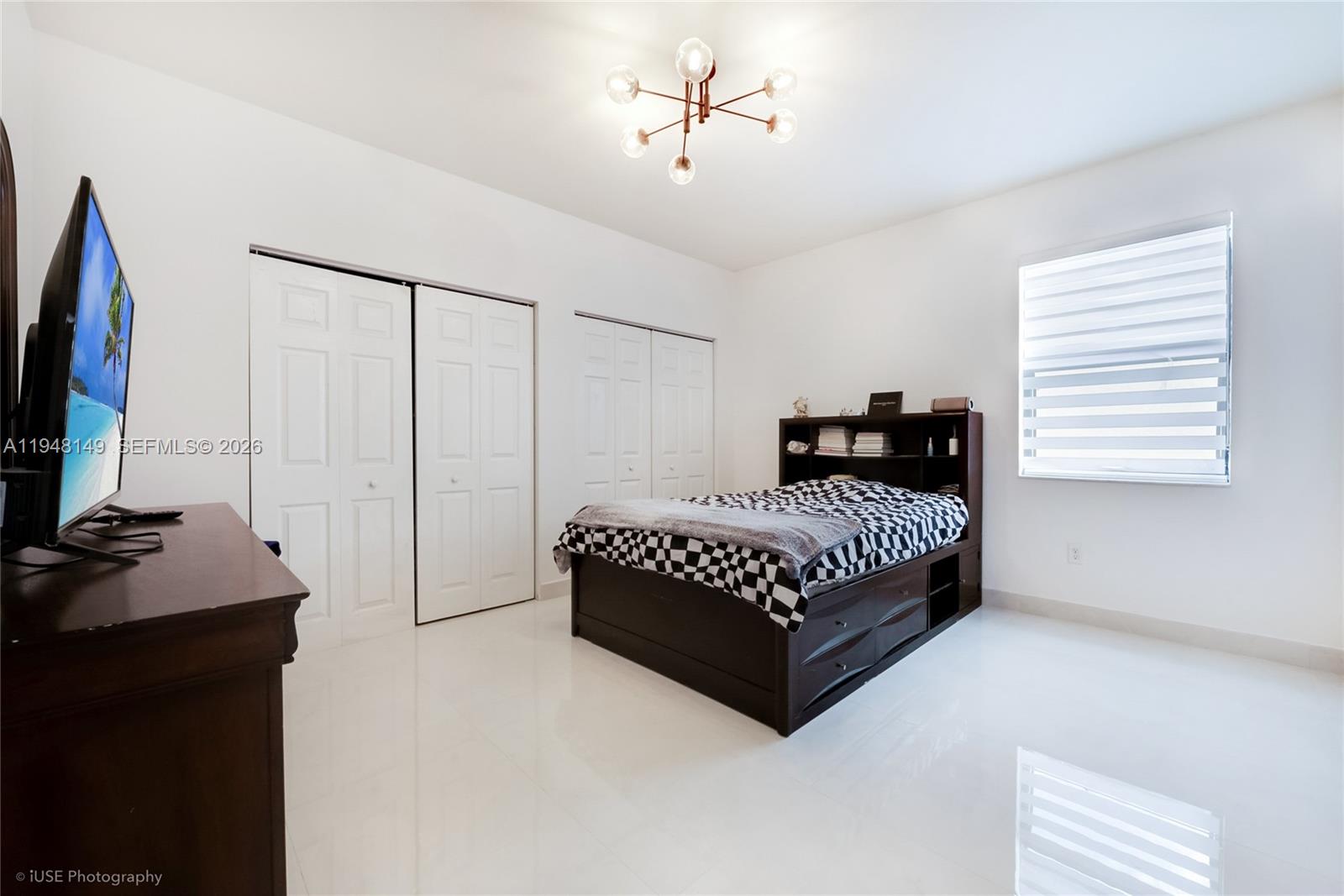 11711 Southwest 254th Street Homestead, FL 33032 - Photo 9 of 17 a bedroom with a bed and a flat tv screen