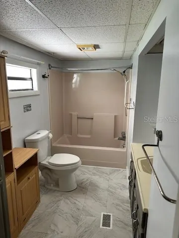 a bathroom with a toilet sink and shower