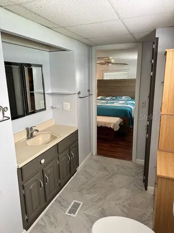 a en suite bathroom with a sink and a mirror