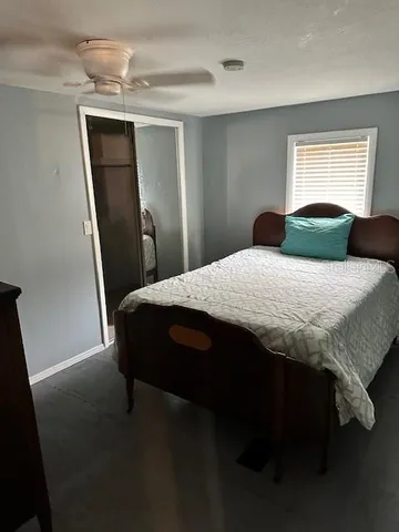 a bedroom with a bed and window