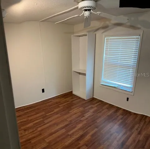 a view of a room with wooden floor