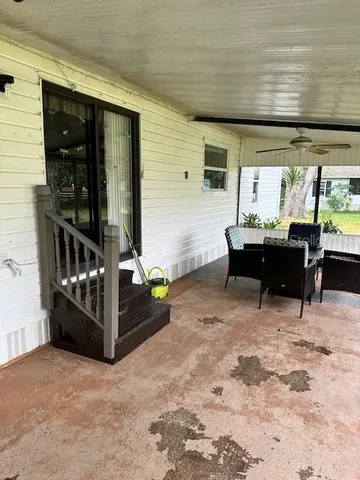 a view of a dining room with furniture large windows and wooden floor