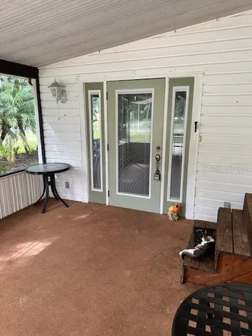 a view of a house with backyard and porch