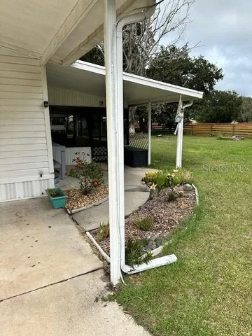 a view of a house with a backyard and a garage