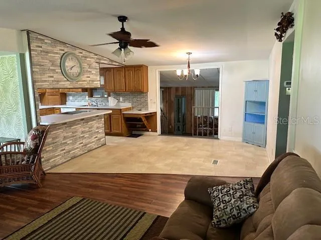a kitchen with granite countertop a stove a sink and a refrigerator