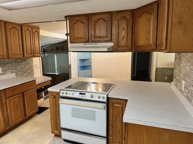 a kitchen with stainless steel appliances granite countertop a stove and a refrigerator