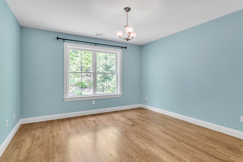 273 Scantic Road Hampden, MA 01036 - Photo 29 of 40 a view of an empty room with wooden floor and a window