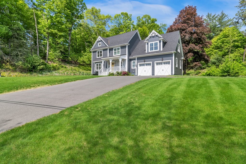 273 Scantic Road Hampden, MA 01036 - Photo 40 of 40 a front view of a house with a yard and garage