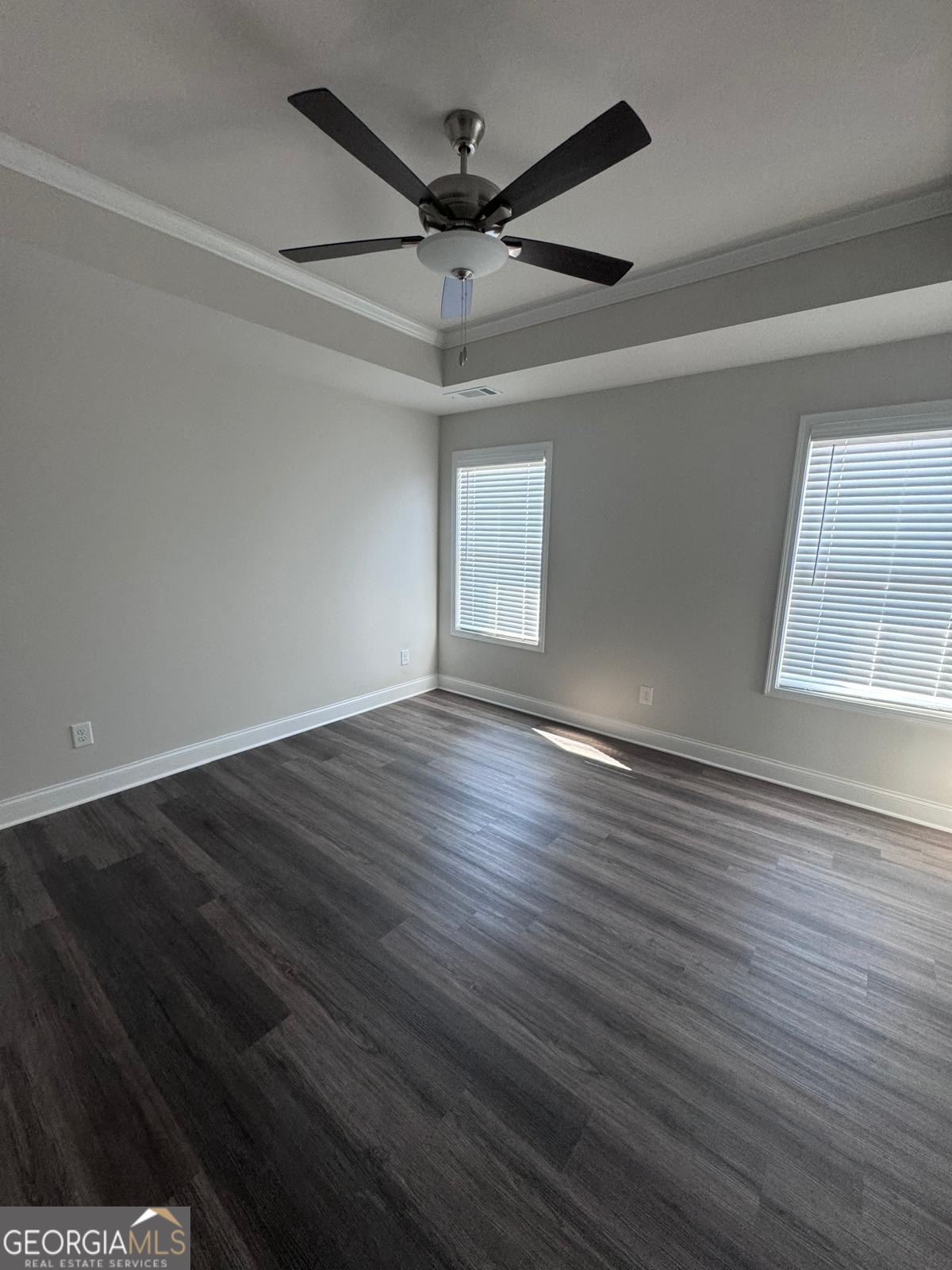 855 Pensive Run Dacula, GA 30019 - Photo 3 of 8 an empty room with wooden floor fan and windows