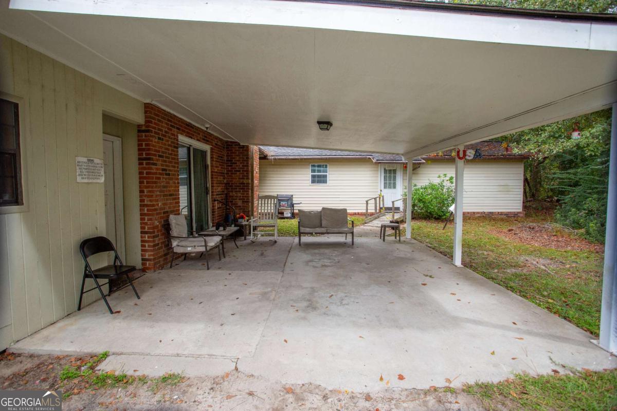 537 City Circle Road Baxley, GA 31513 - Photo 2 of 33 a view of a patio with table and chairs a barbeque