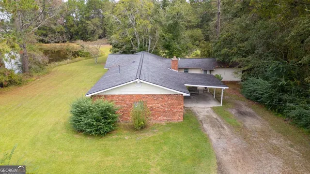 a view of a lake with large trees